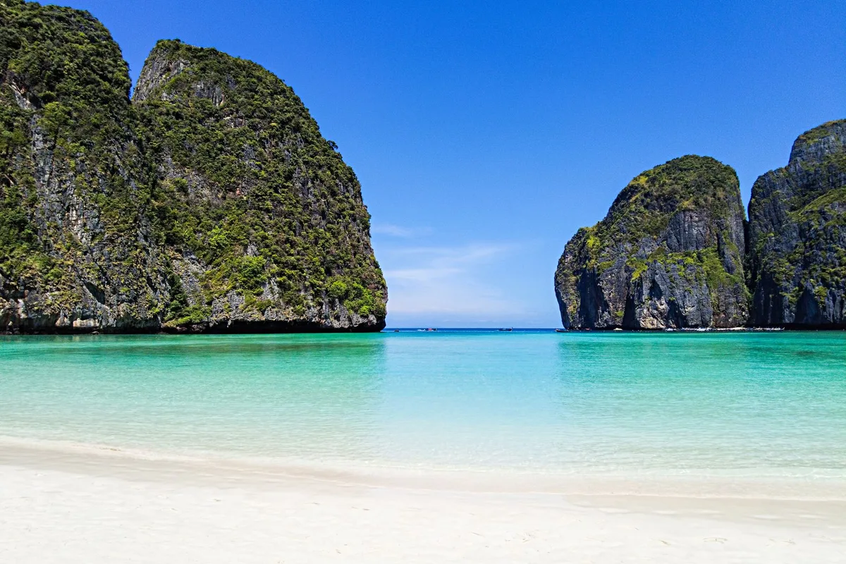 Maya Bay's white sand and turquoise water between the cliffs of Koh Phi Phi Leh