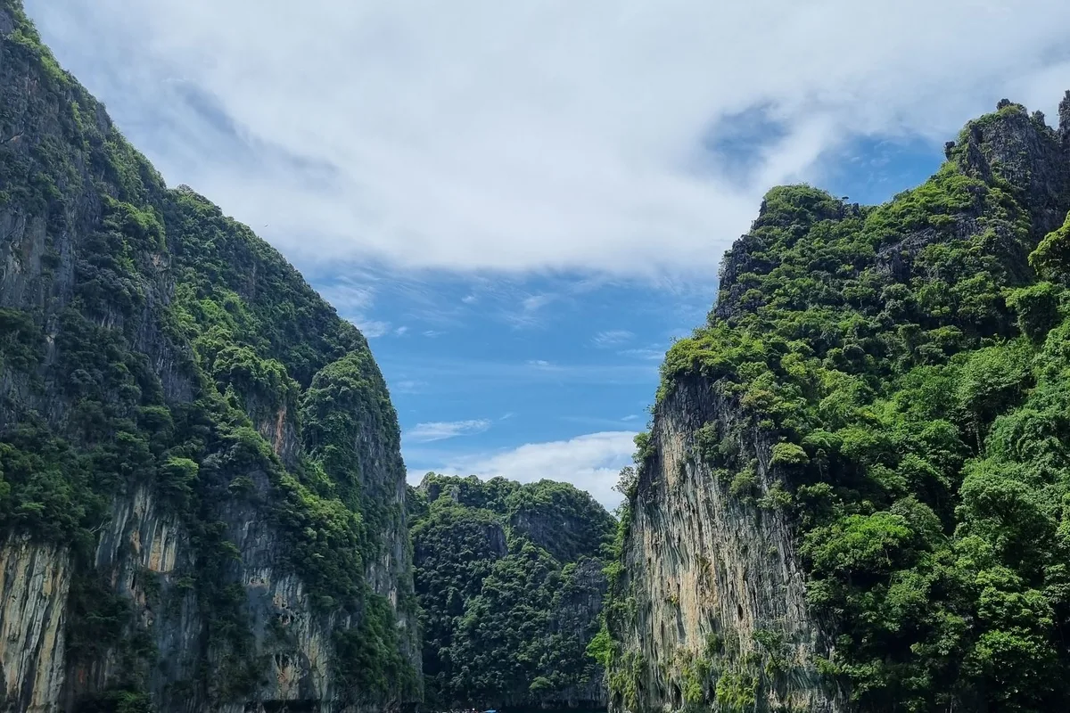 An emerald lagoon enclosed by towering limestone cliffs in the Phi Phi Islands