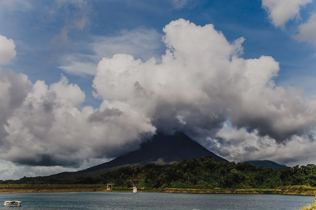 Arenal Volcano under cloud across Lake Arenal