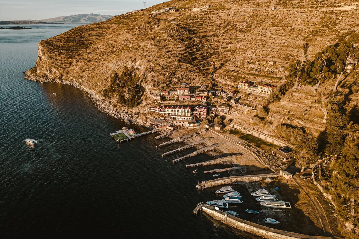 The harbour at Yumani on Isla del Sol, boats below the terraced hillside