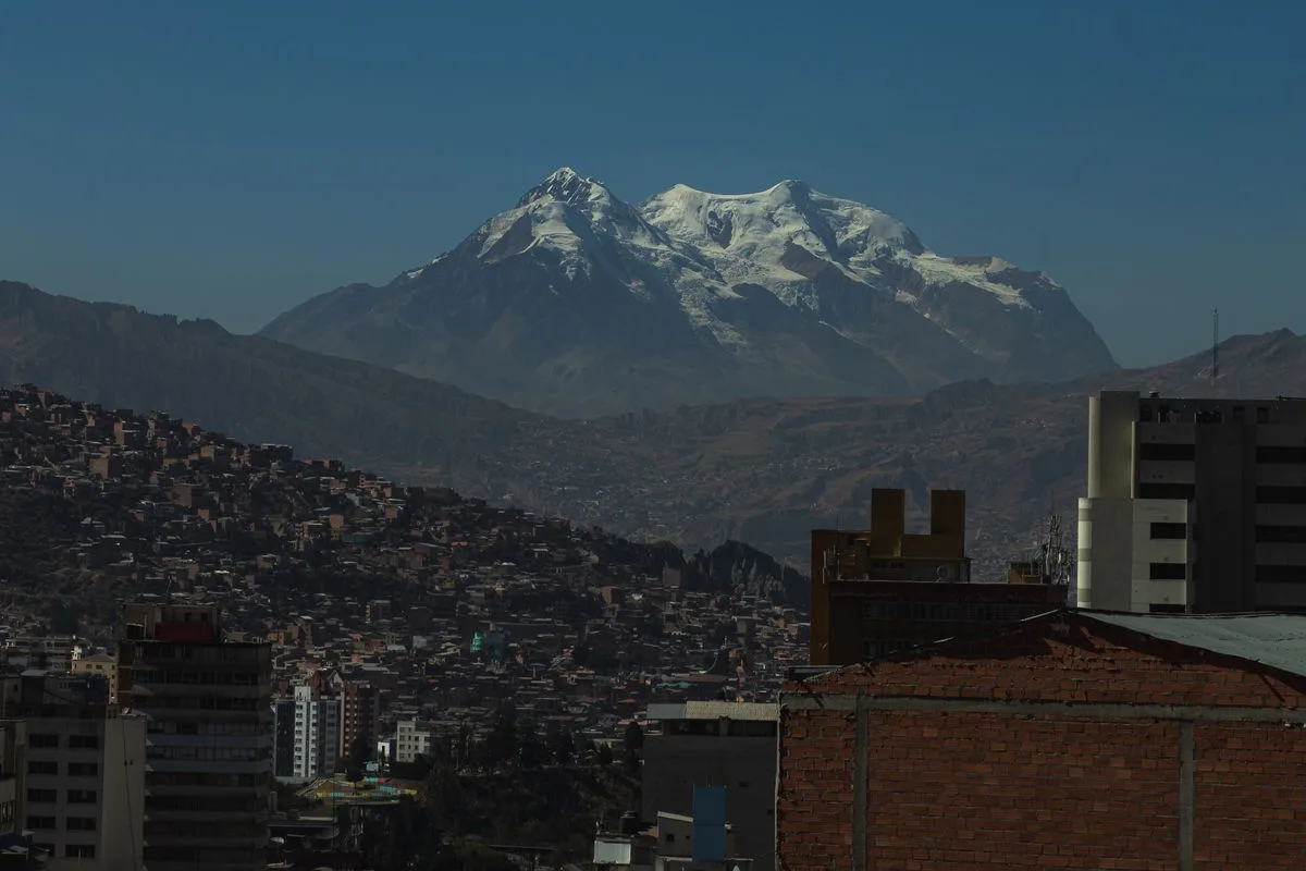 Illimani's snow peaks rising above the rooftops of La Paz