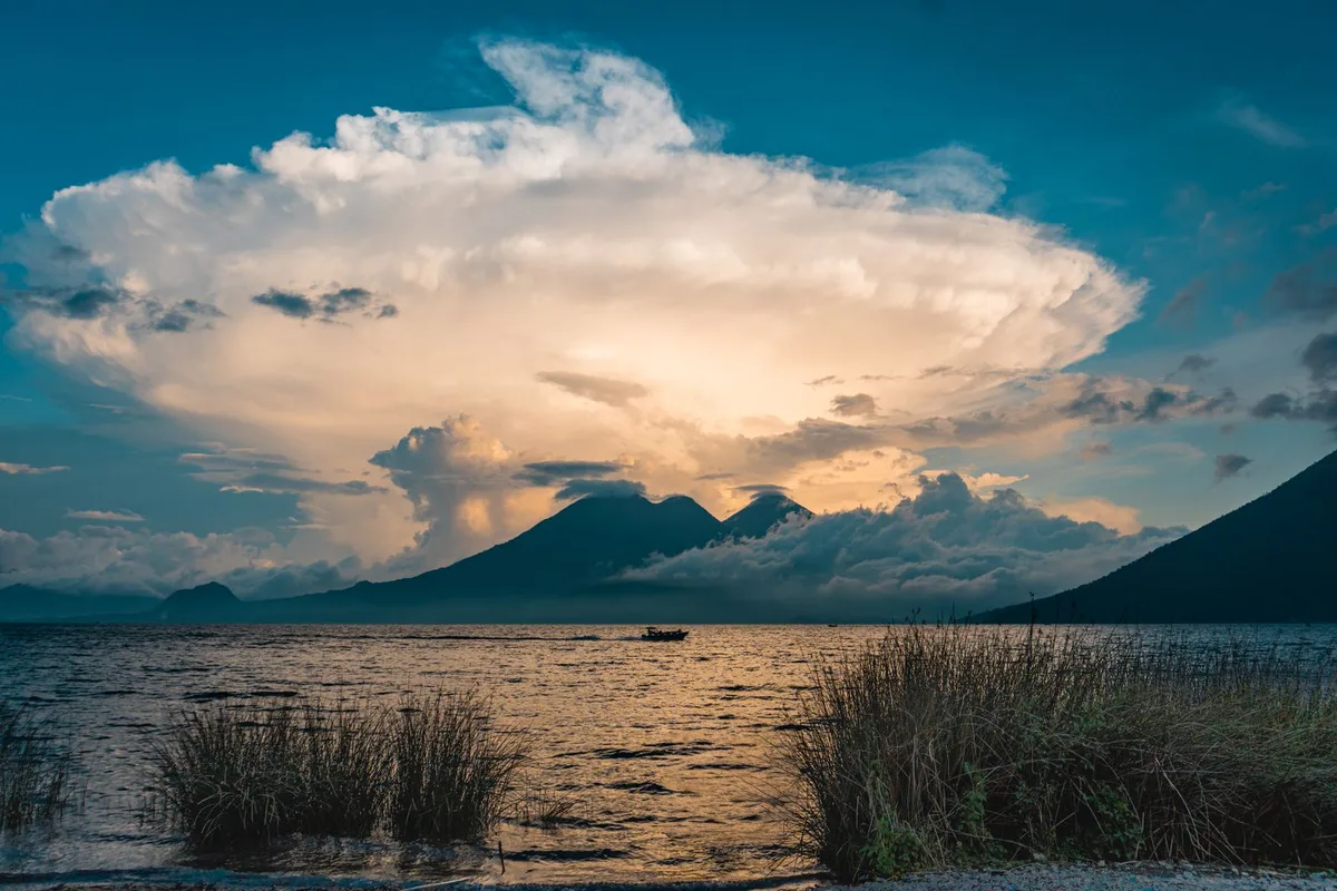A storm cloud building over Lake Atitlán at sunset in the rainy season