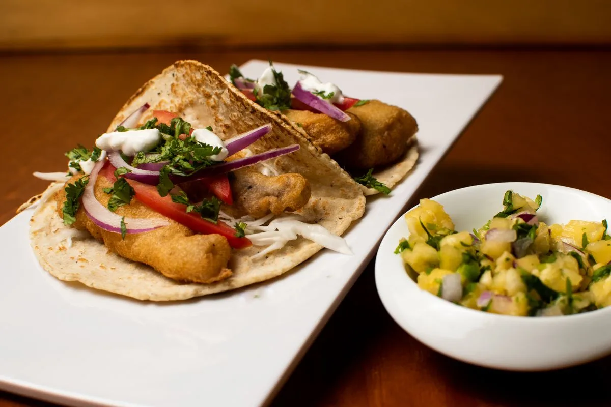 Baja fish tacos with fresh salsa on a white plate
