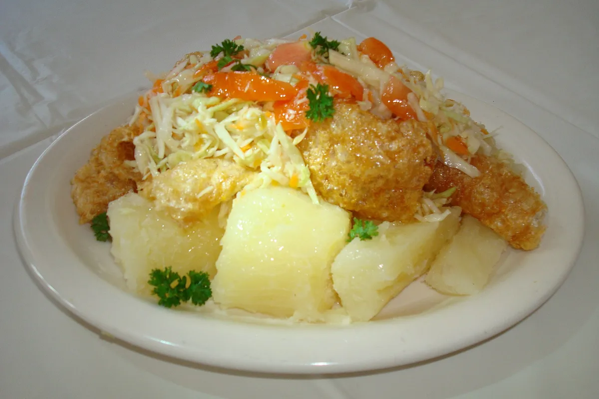 A plate of vigorón — yuca, cabbage slaw and chicharrones served on a banana leaf