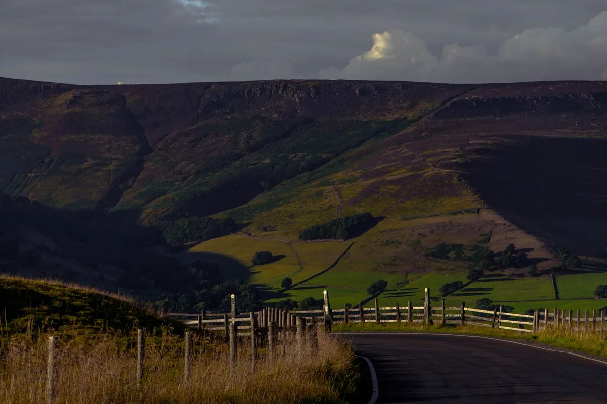 A lane crossing open moorland in the Peak District