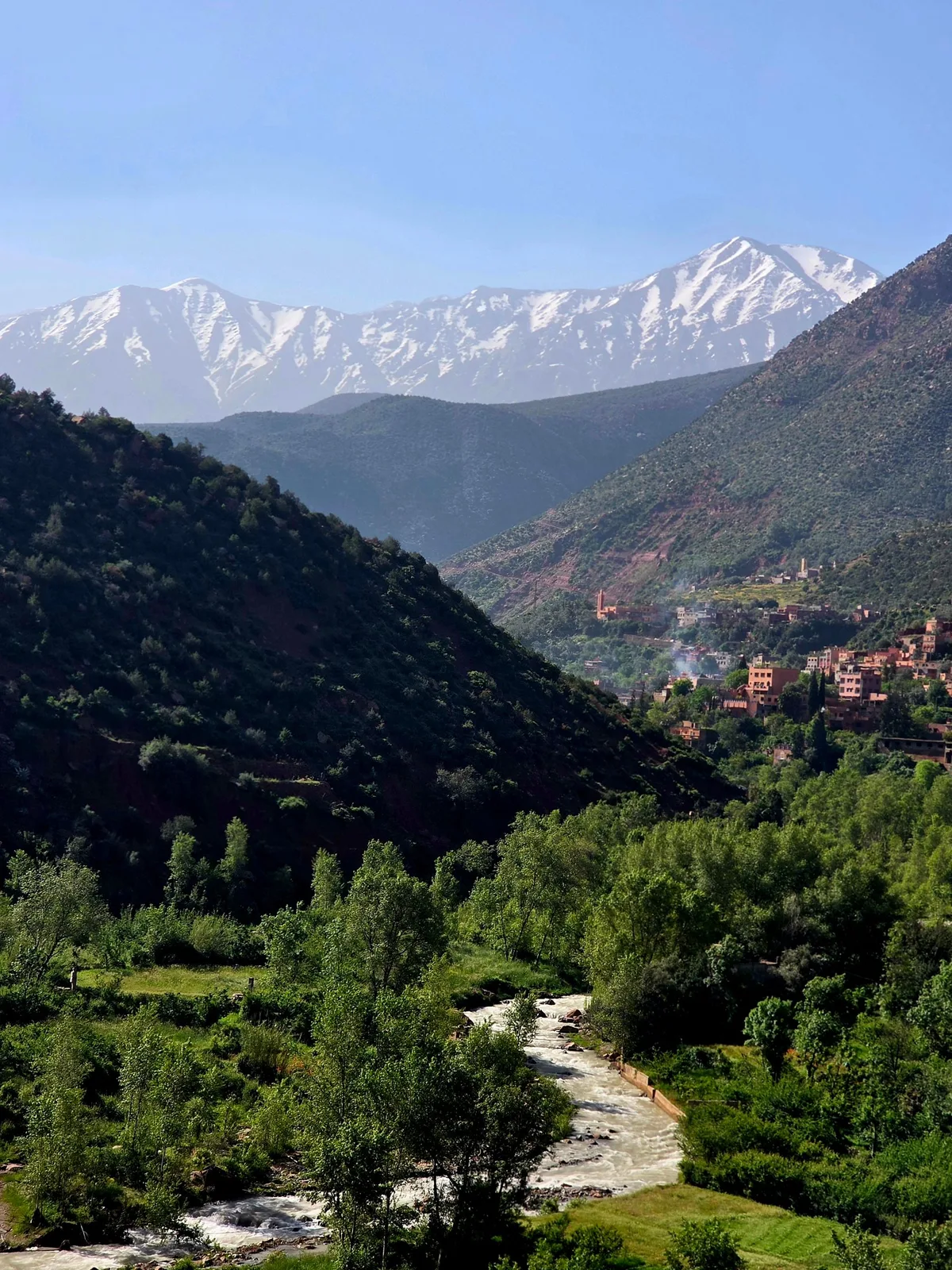 The Ourika Valley river below snow-capped Atlas peaks