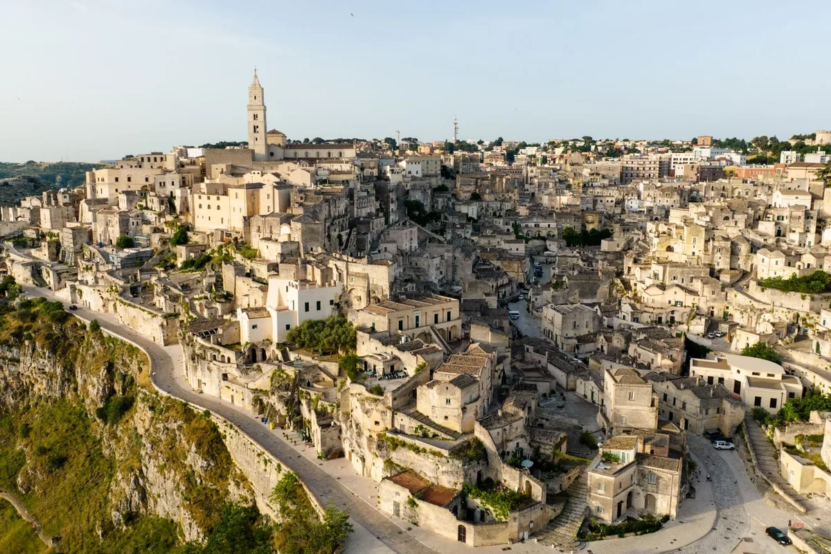 The Sassi of Matera spread across the ravine slope, the Duomo tower above the cave houses