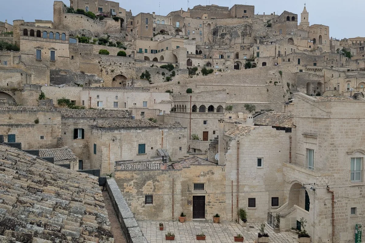 The Sassi amphitheatre of cave houses climbing to the Civita in bright morning light