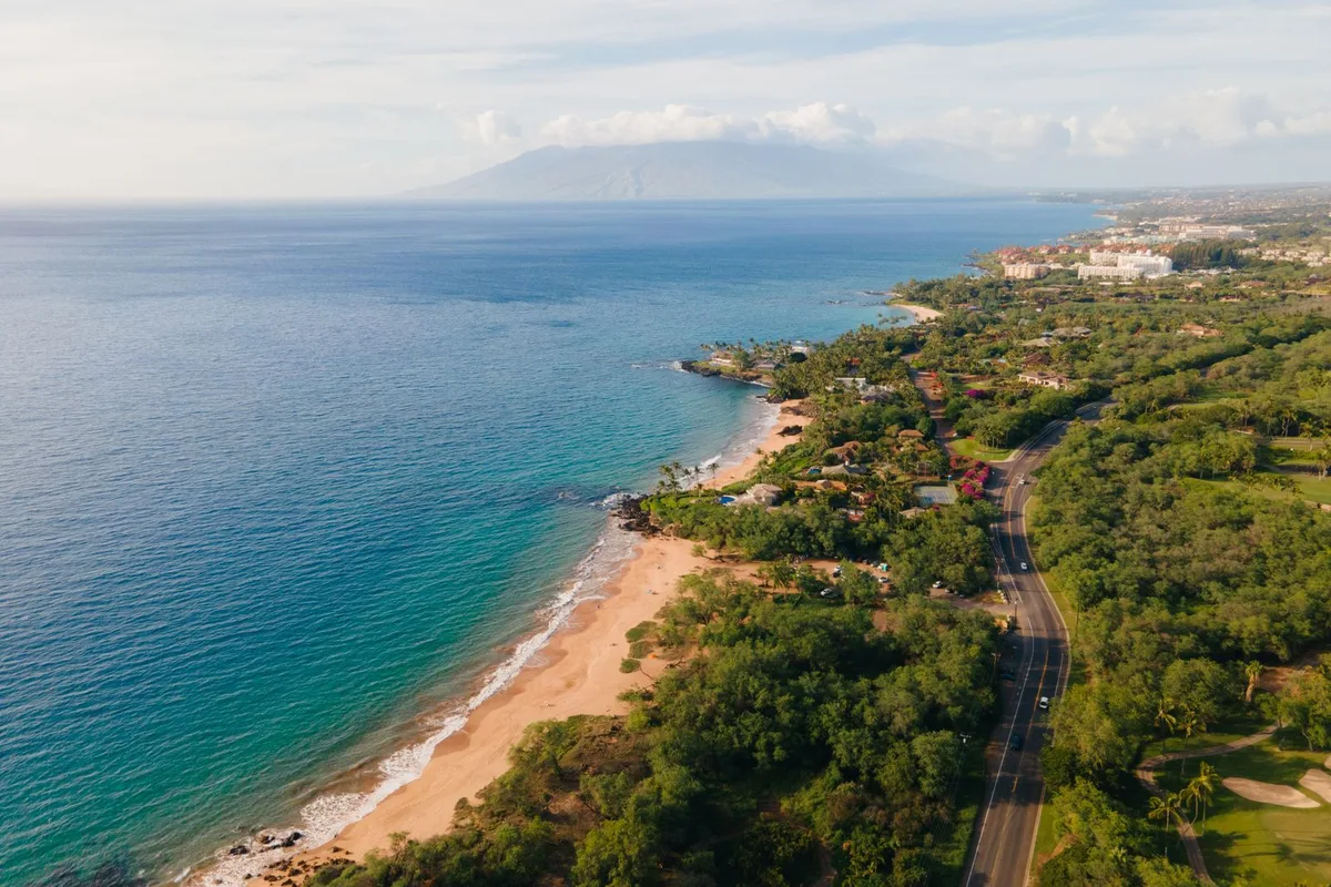 The Kihei coastline from the air, the coast road running beside the shore