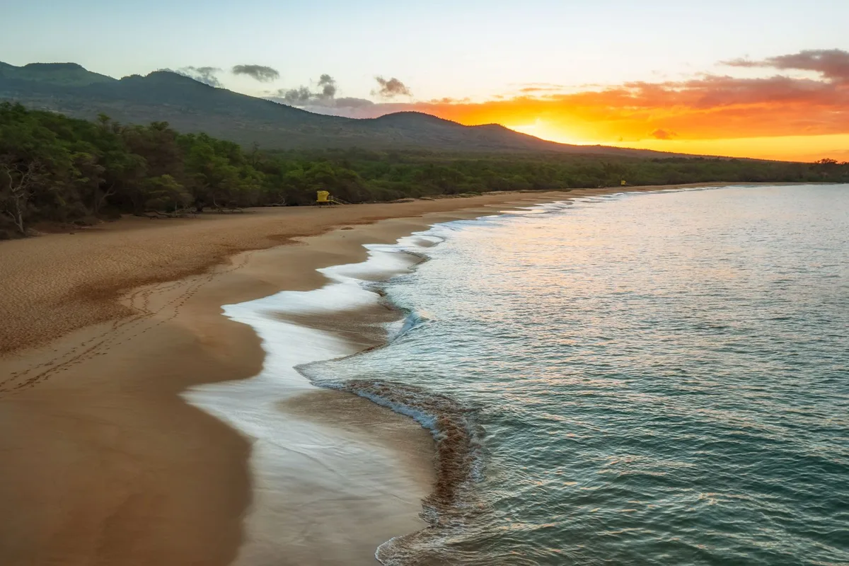 Last light over a quiet beach as the tide runs in