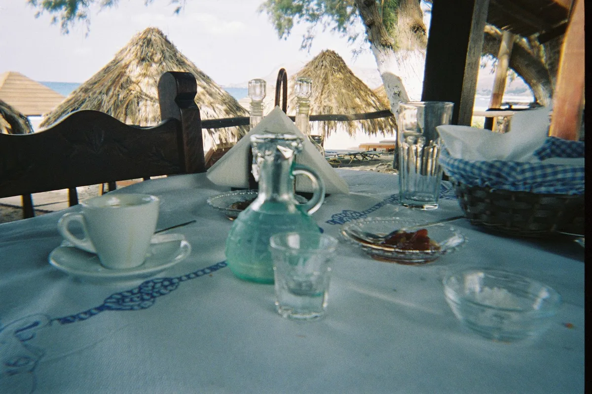 Pasta and a glass of wine on a taverna table