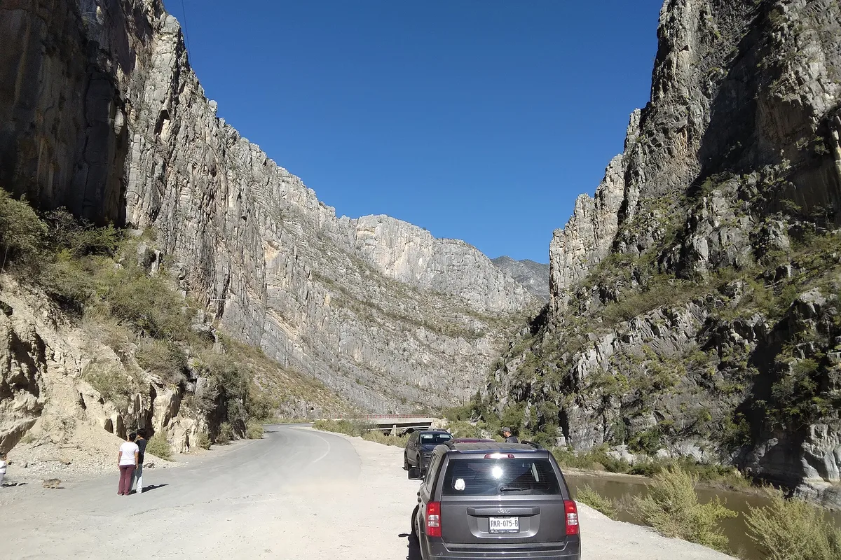The road running through the grey limestone walls of La Huasteca canyon