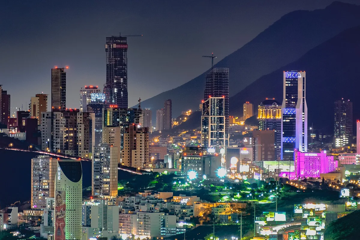 The Monterrey skyline lit at night beneath the mountains