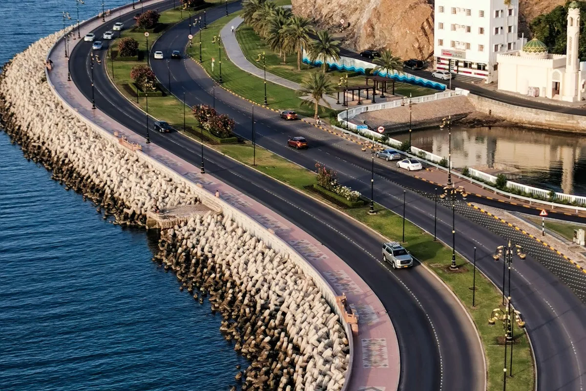 An aerial view of the Mutrah Corniche, the harbour road curving along the bay below Mutrah Fort