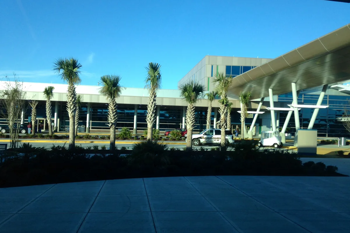 The terminal at Myrtle Beach International Airport, palm trees in front of the main entrance