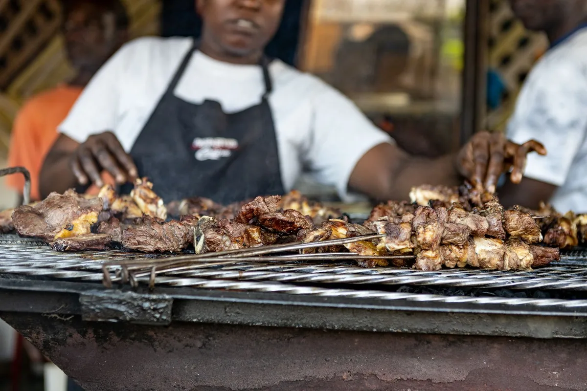 Nyama choma grilling over charcoal at a Nairobi grill counter