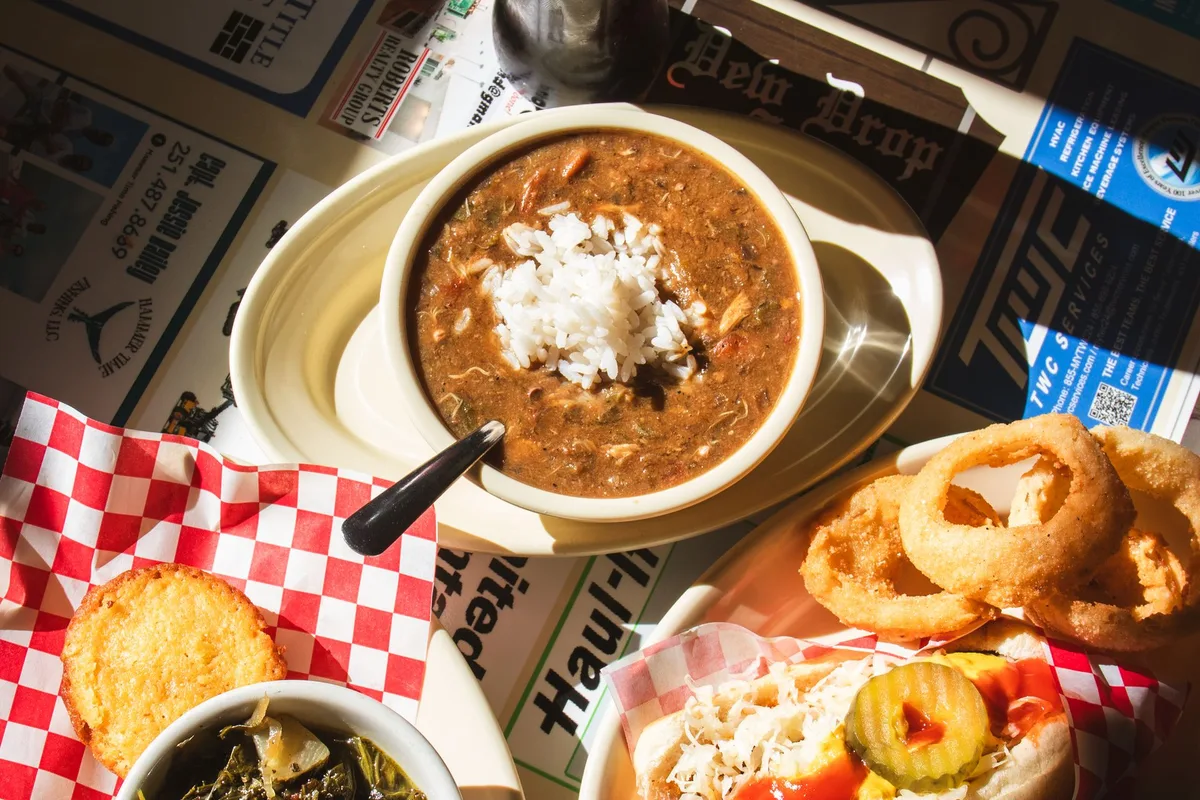 A Louisiana plate with gumbo, greens and a po'boy