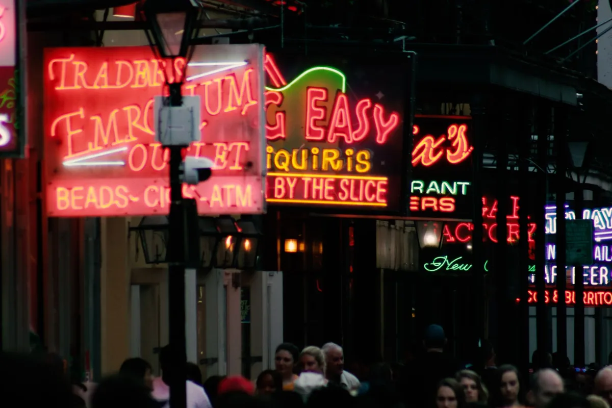 Bourbon Street at night under the neon signs