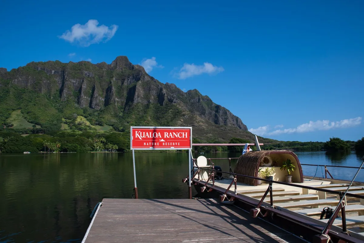 The Kualoa Ranch fishpond dock under the green Koolau cliffs