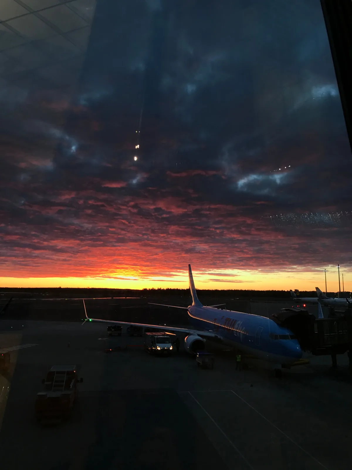 A jet at the gate under a dawn sky