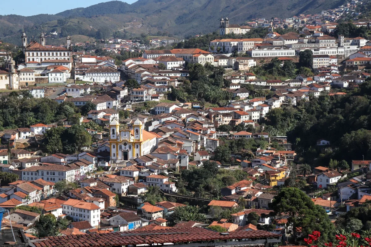 Ouro Preto spilling over its hills, colonial rooftops and church towers above the valley