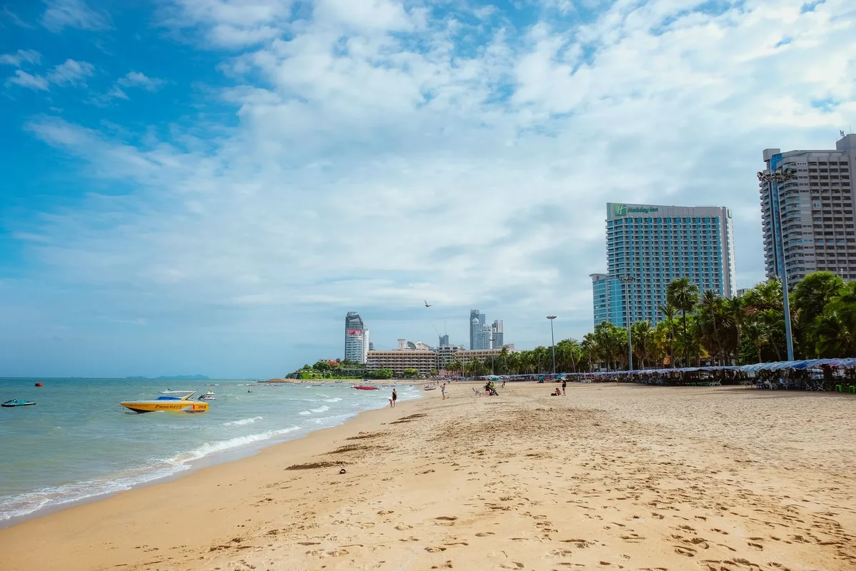A wide sandy beach and hotel towers in Pattaya