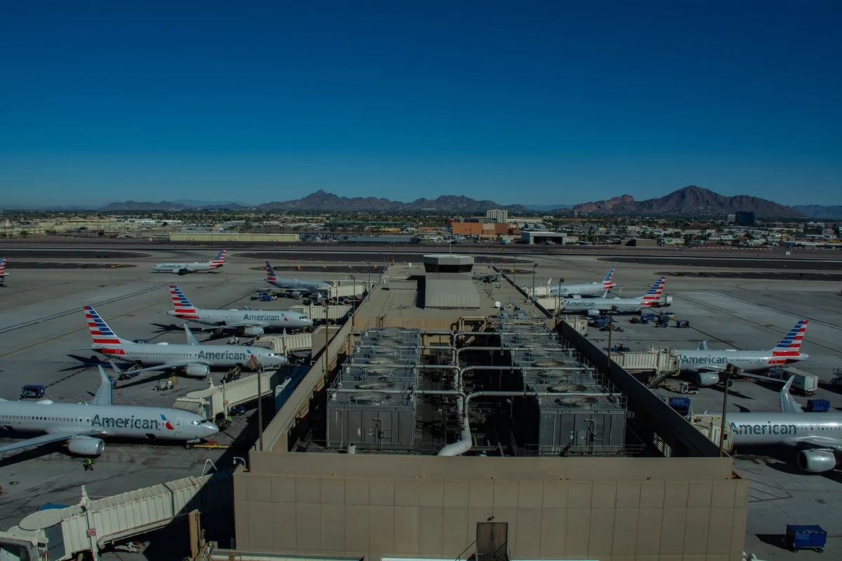American Airlines jets at the gates at Phoenix Sky Harbor, Camelback Mountain behind