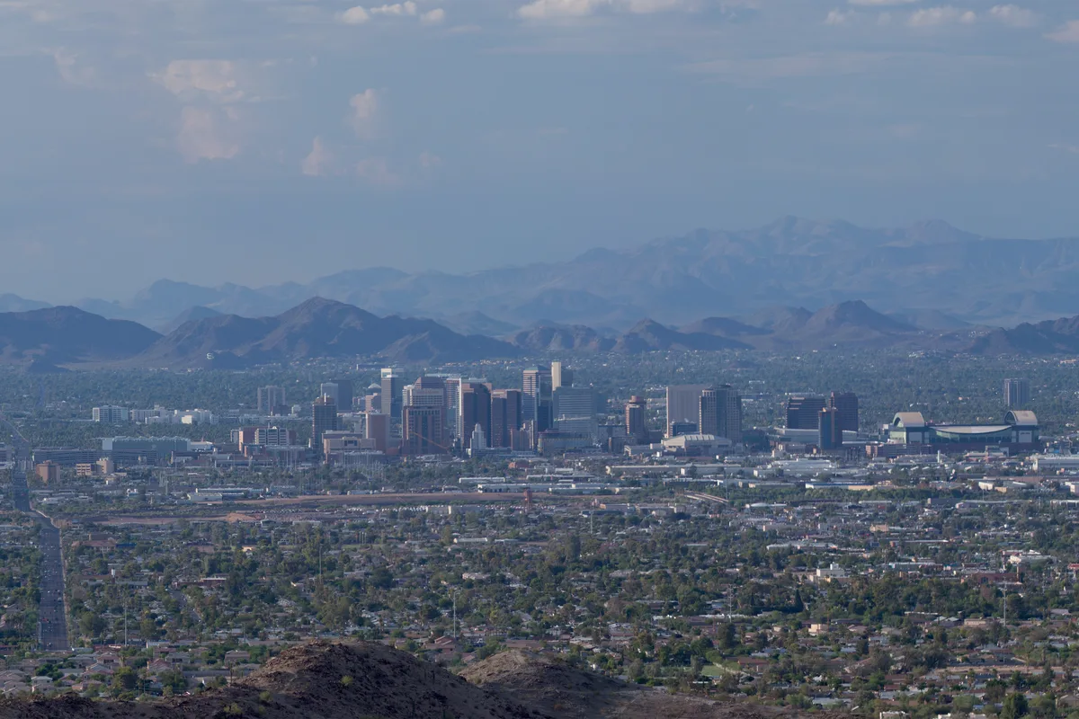 The downtown Phoenix skyline from South Mountain, desert ranges behind