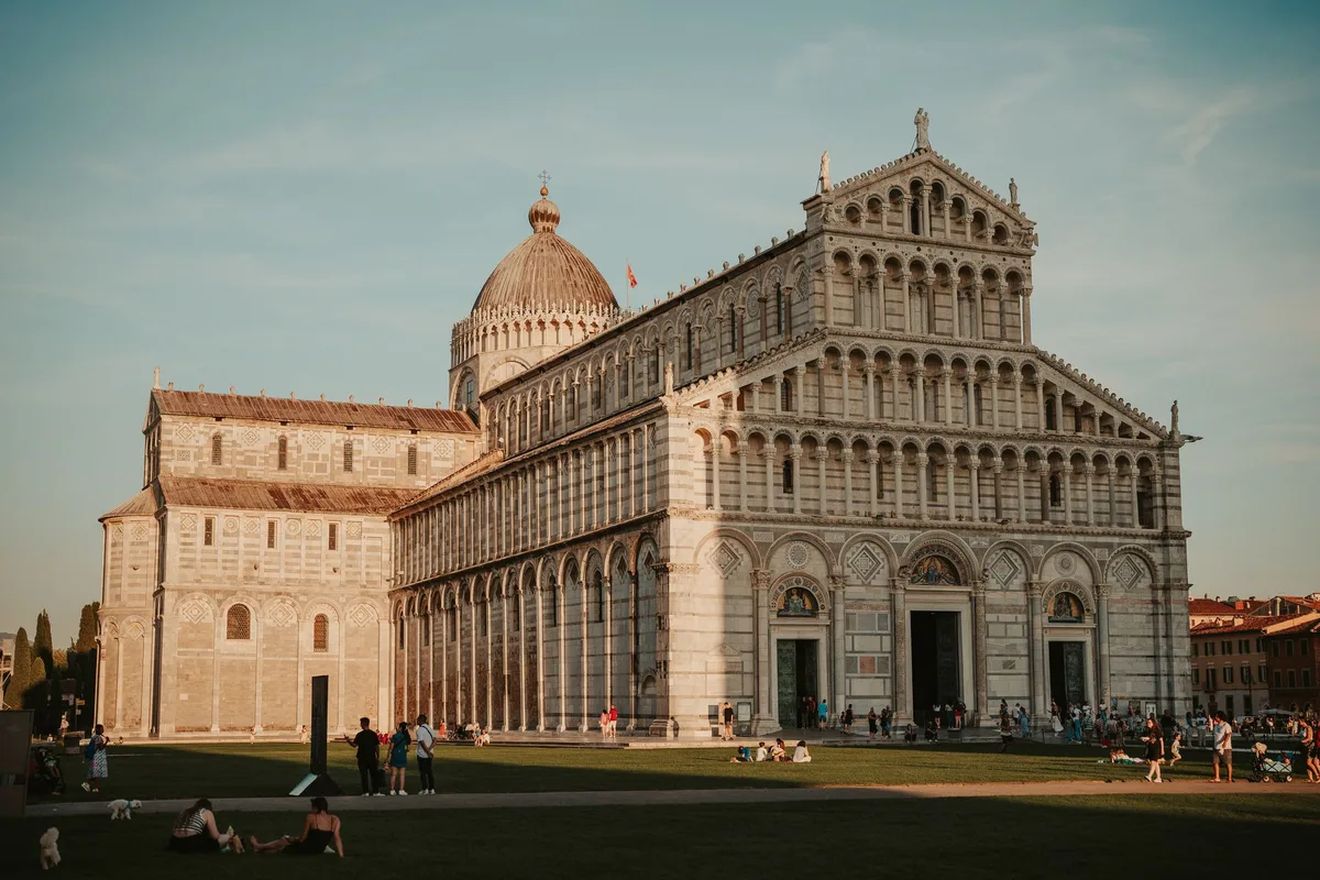 Pisa Cathedral's Romanesque facade across the lawn of Piazza dei Miracoli