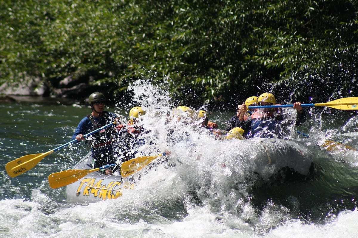 A rafting crew paddling through white water on the Trancura River near Pucón