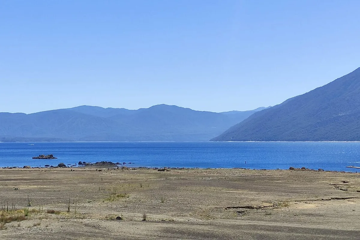 Lake Caburgua near Pucón, its shore under a summer sky