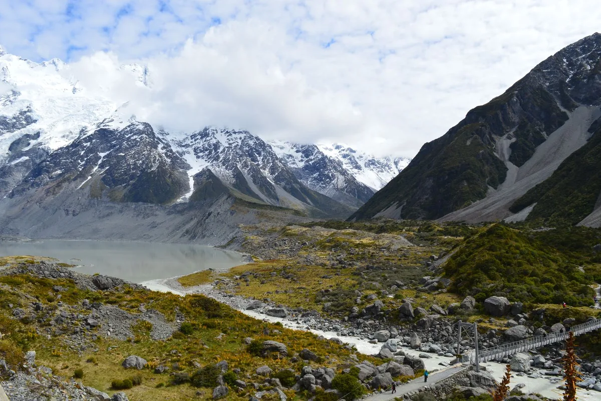 The Hooker Valley track crossing a swing bridge below Aoraki Mount Cook