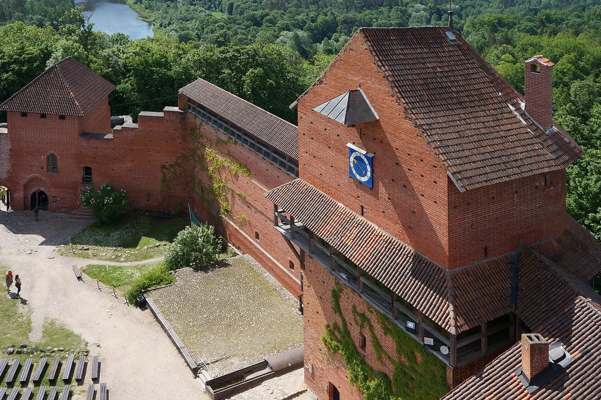 The red-brick towers of Turaida Castle above the Gauja valley forest