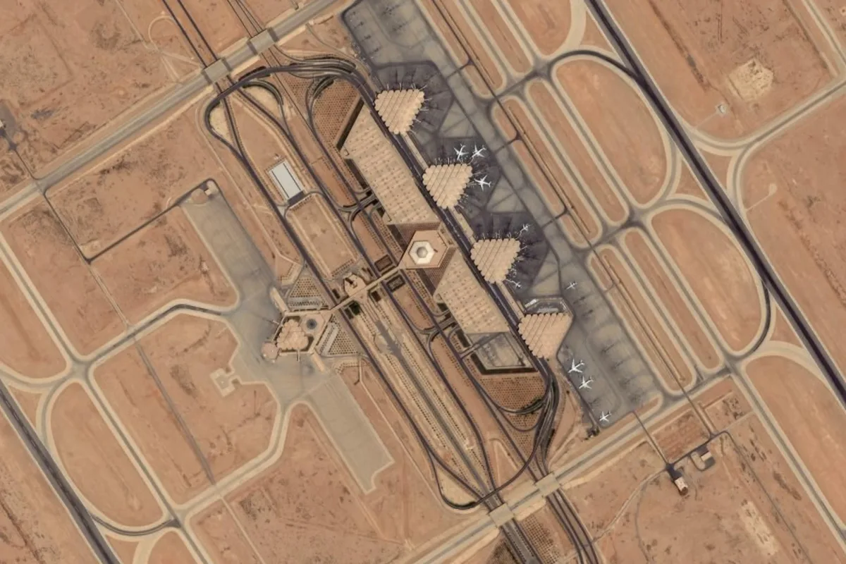 King Khalid International Airport in Riyadh seen from above, its tent-roofed terminals on the desert plateau