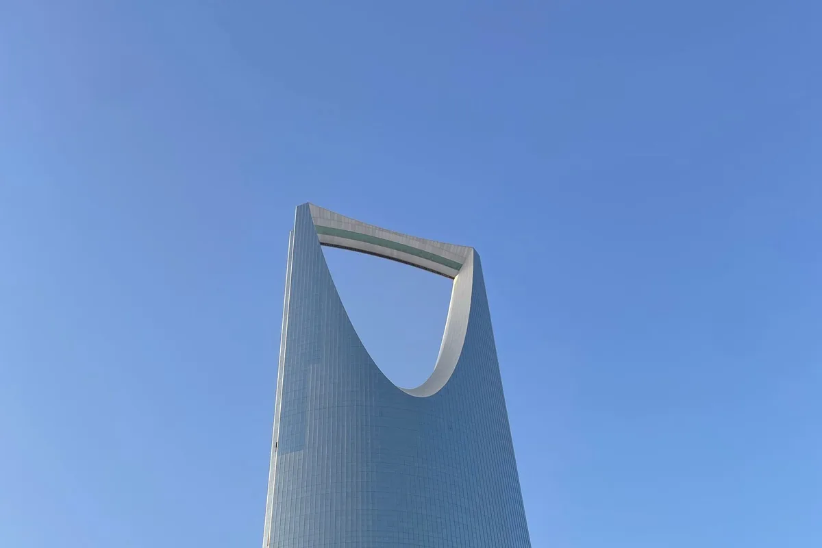 The Kingdom Centre tower and its inverted arch against a clear blue sky in Riyadh
