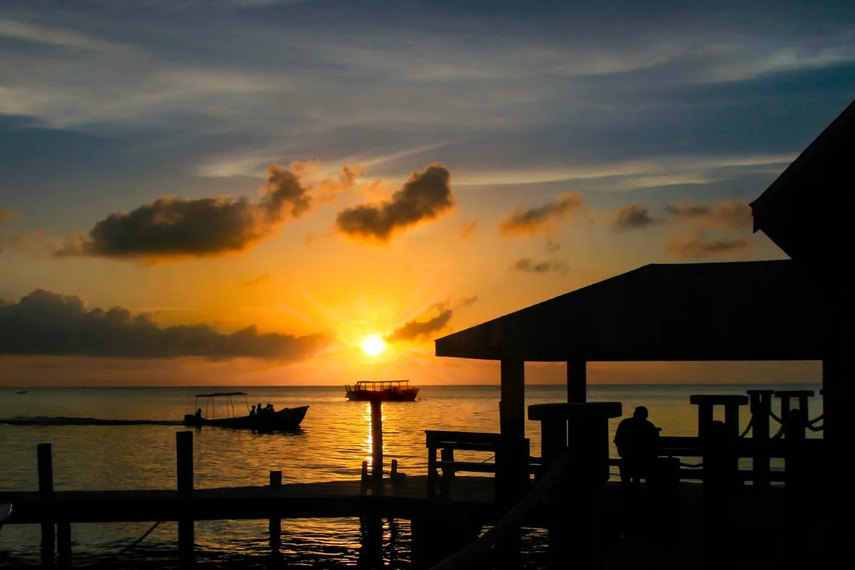Sunset over a dock on Roatan's west end