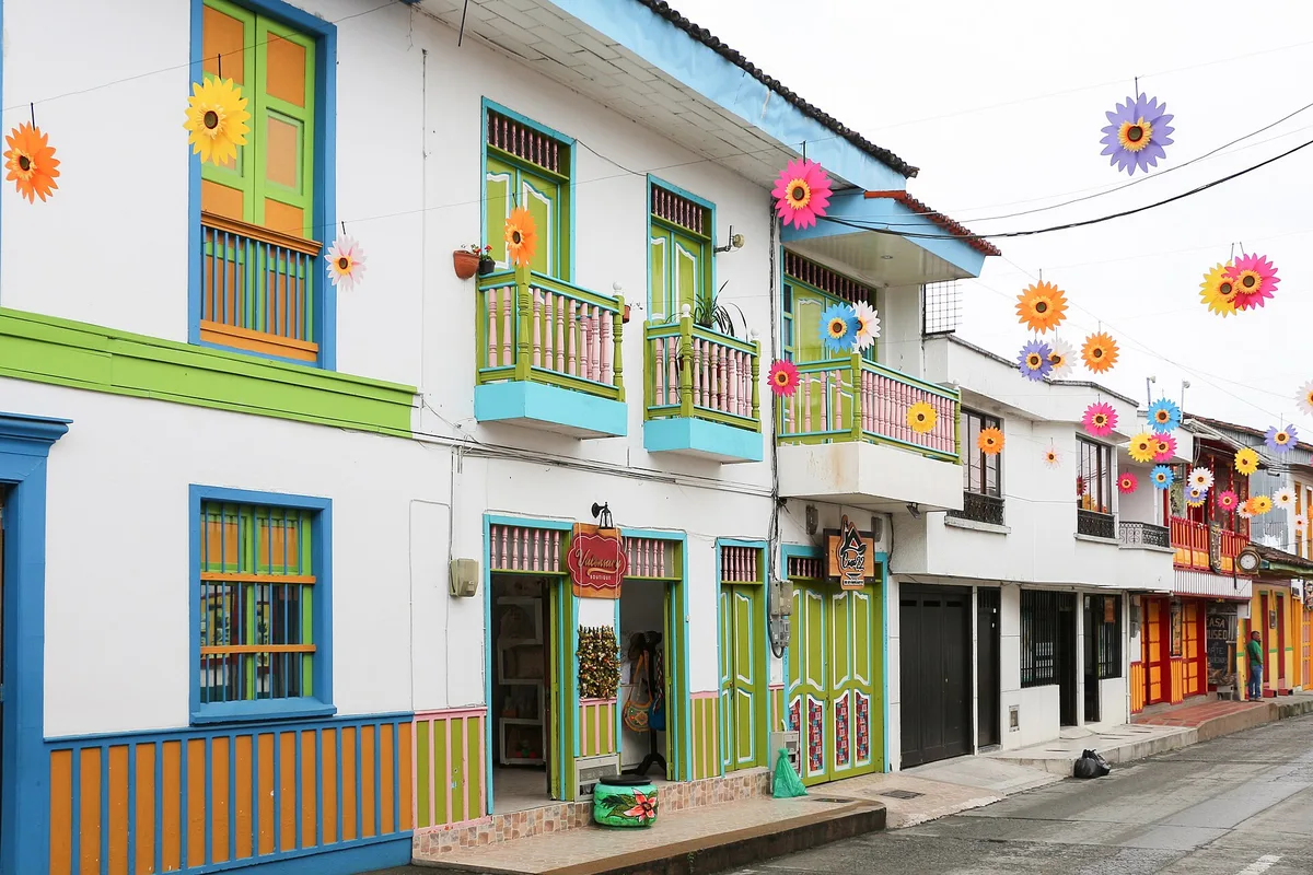 A painted street in Filandia, hung with paper flowers for a festival