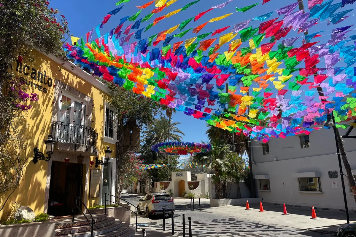 A canopy of colourful flags over a street in San José del Cabo
