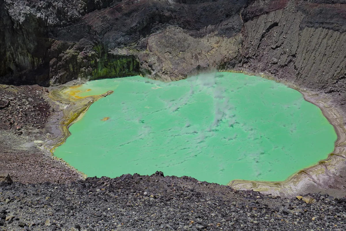 The green sulphur lake inside the crater of Santa Ana volcano