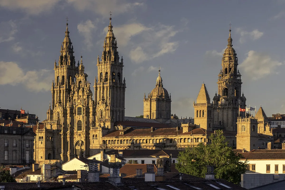 The twin towers of Santiago Cathedral from the Alameda park in golden evening light