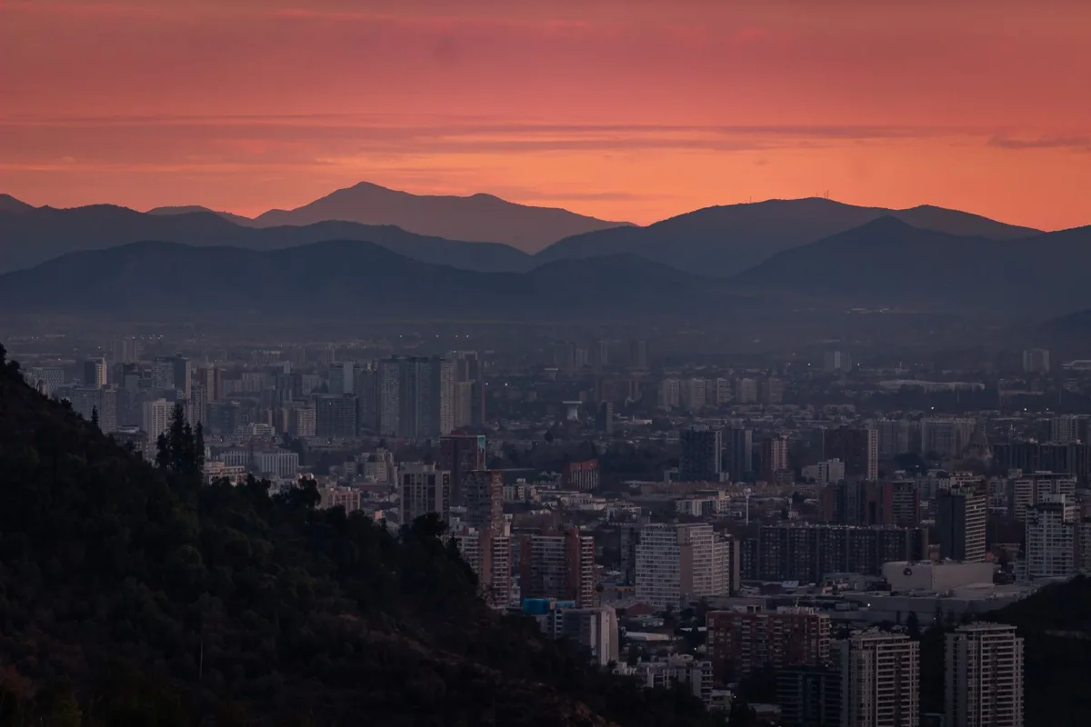 Santiago at sunset, the city below the dark outline of the Andes