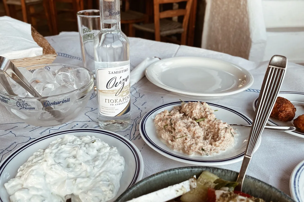 Greek salad, tzatziki and ouzo on a taverna table