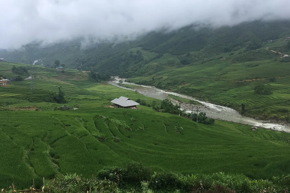 The Muong Hoa river winding through green terraces below Sapa