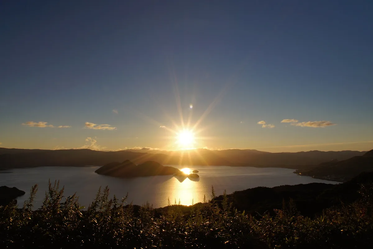 The sun setting over Lake Toya and Nakajima Island from the Silo Observatory side