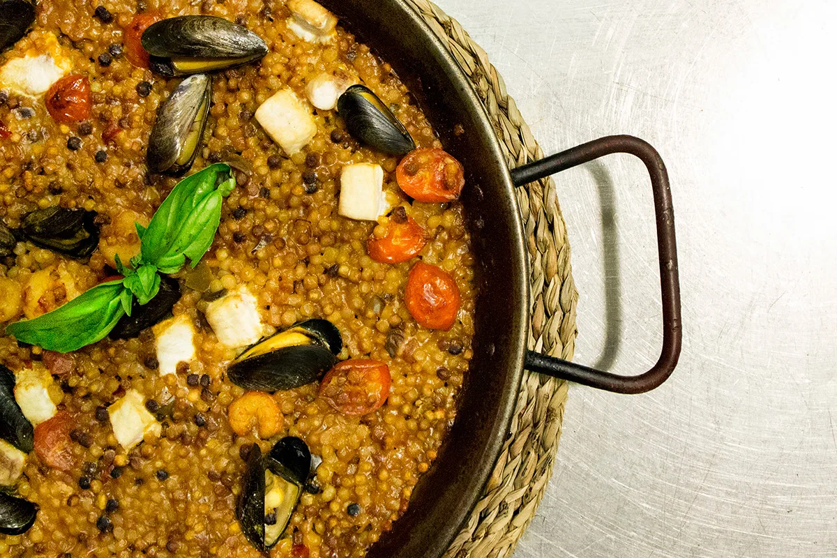 A pan of fregola with mussels and clams, Sardinia's toasted semolina pasta