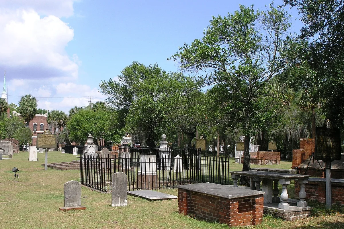 Colonial Park Cemetery's old gravestones under moss-draped oaks