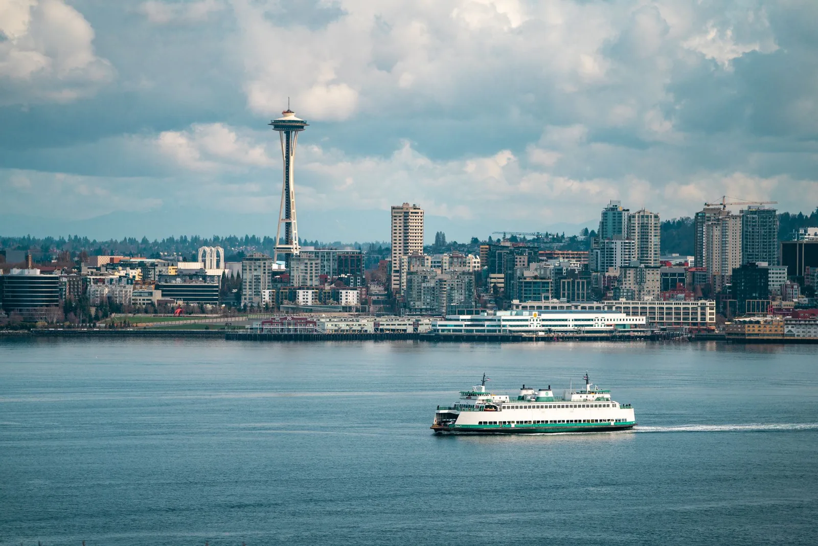A Washington State ferry crossing Elliott Bay with the Space Needle behind