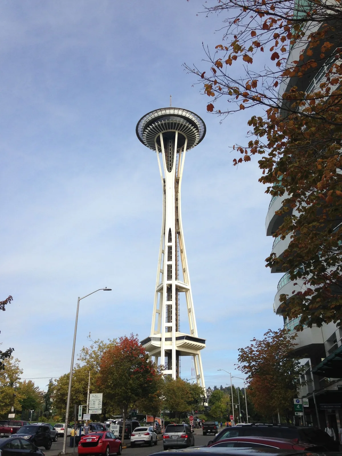 The Space Needle from street level through autumn trees