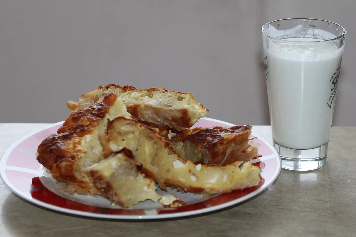 A banitsa filo pastry with a glass of yogurt drink, the classic Bulgarian breakfast