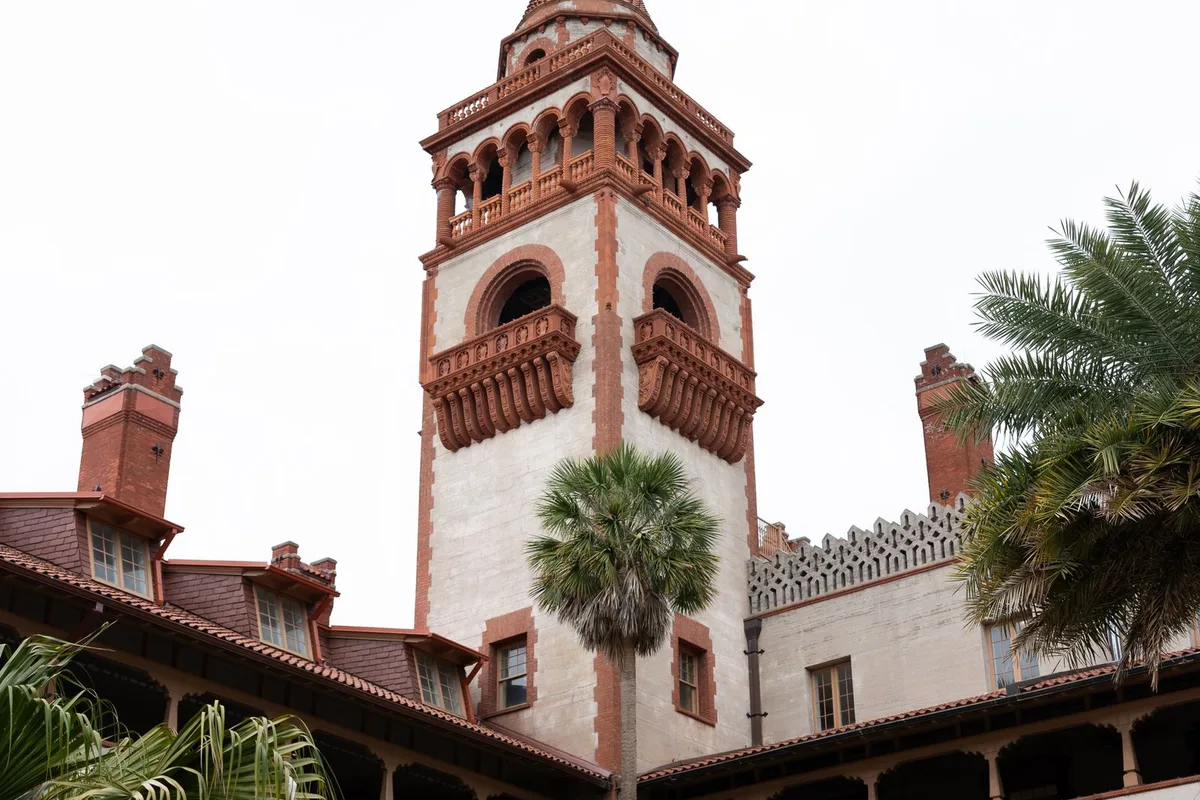The tower of Flagler College, the former Ponce de León Hotel, above the palms